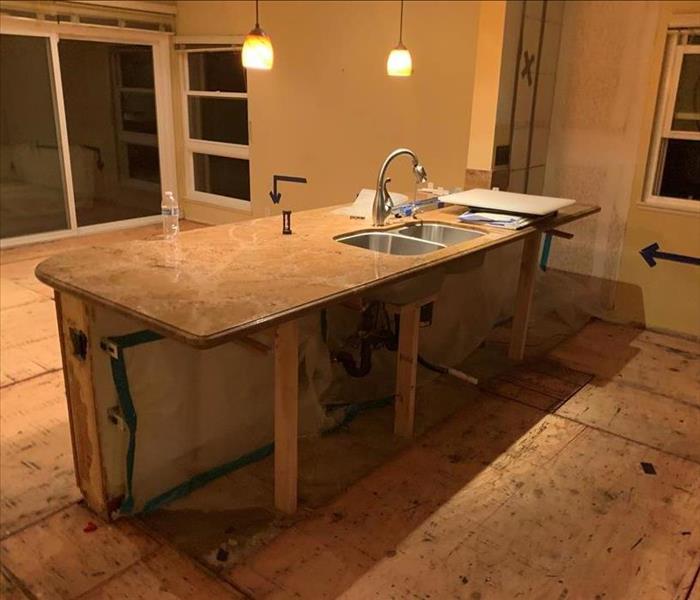 Picture of the kitchen after demolition with cabinetry removed. 