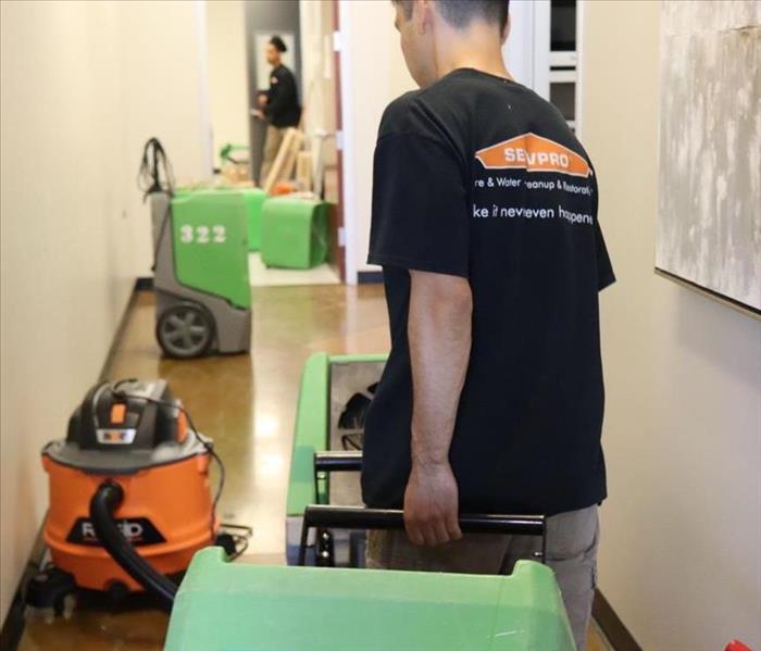 Technicians Roll in Dehumidifier